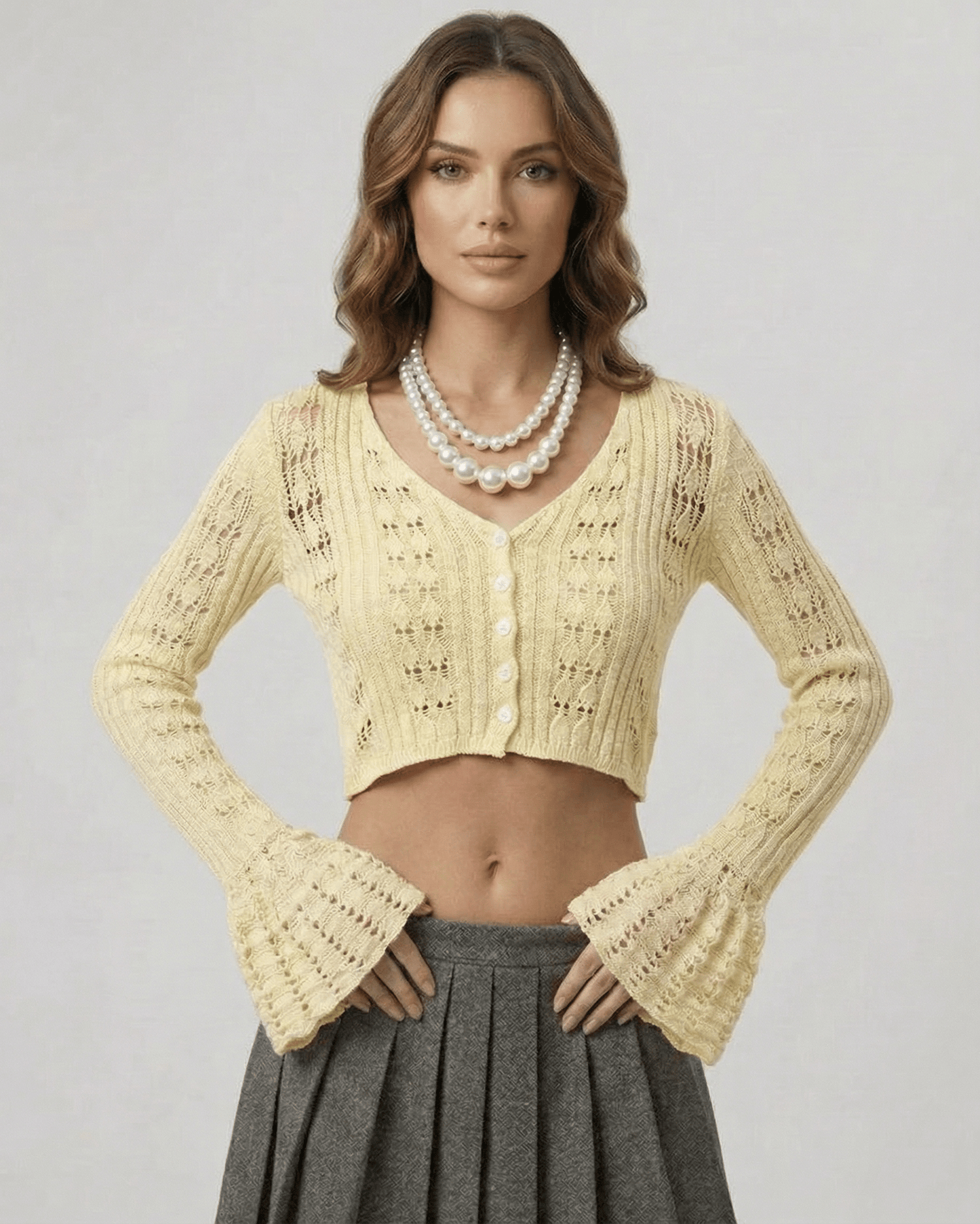 Solene Cardigan featuring a cropped silhouette, soft yellow knit, V-neckline, and intricate detailing by Lauven.