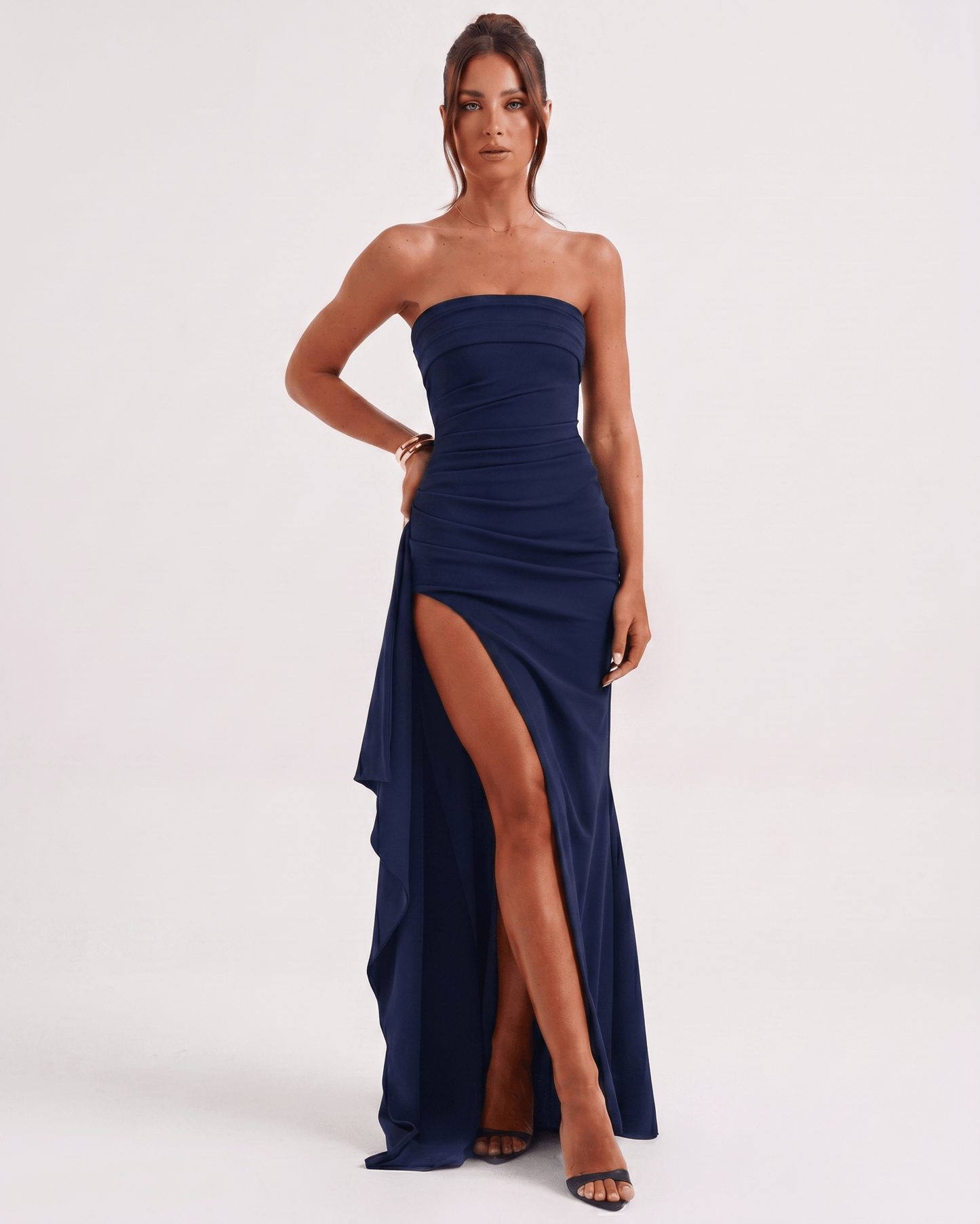 Solenne Maxi Dress in navy with bandeau style, high waist, side slit, and asymmetrical panel for a modern look by Lauven.