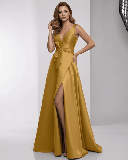 Solenne Maxi Dress - Luxurious golden satin A-line dress with wrap slit and bow detail from Lauven, exuding elegance.