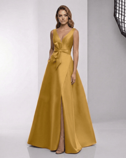 Solenne Maxi Dress - Satin A-Line dress in golden hue with wrap slit and bow detail by Lauven.