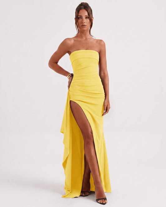 Solenne Maxi Dress by Lauven in yellow, featuring a bandeau design, side slit, and asymmetric panel for a modern look.
