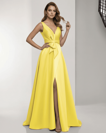 Solenne Maxi Dress featuring a satin A-line design, V-neck, bow detail, vibrant yellow color, by Lauven.