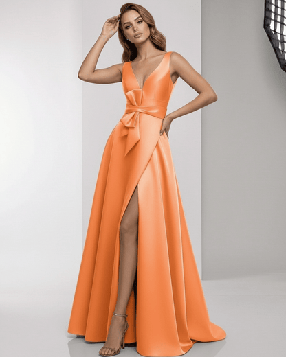 Solmira Maxi Dress – Orange satin A-line dress with wrap slit, bow waist, and elegant V-neckline by Lauven.