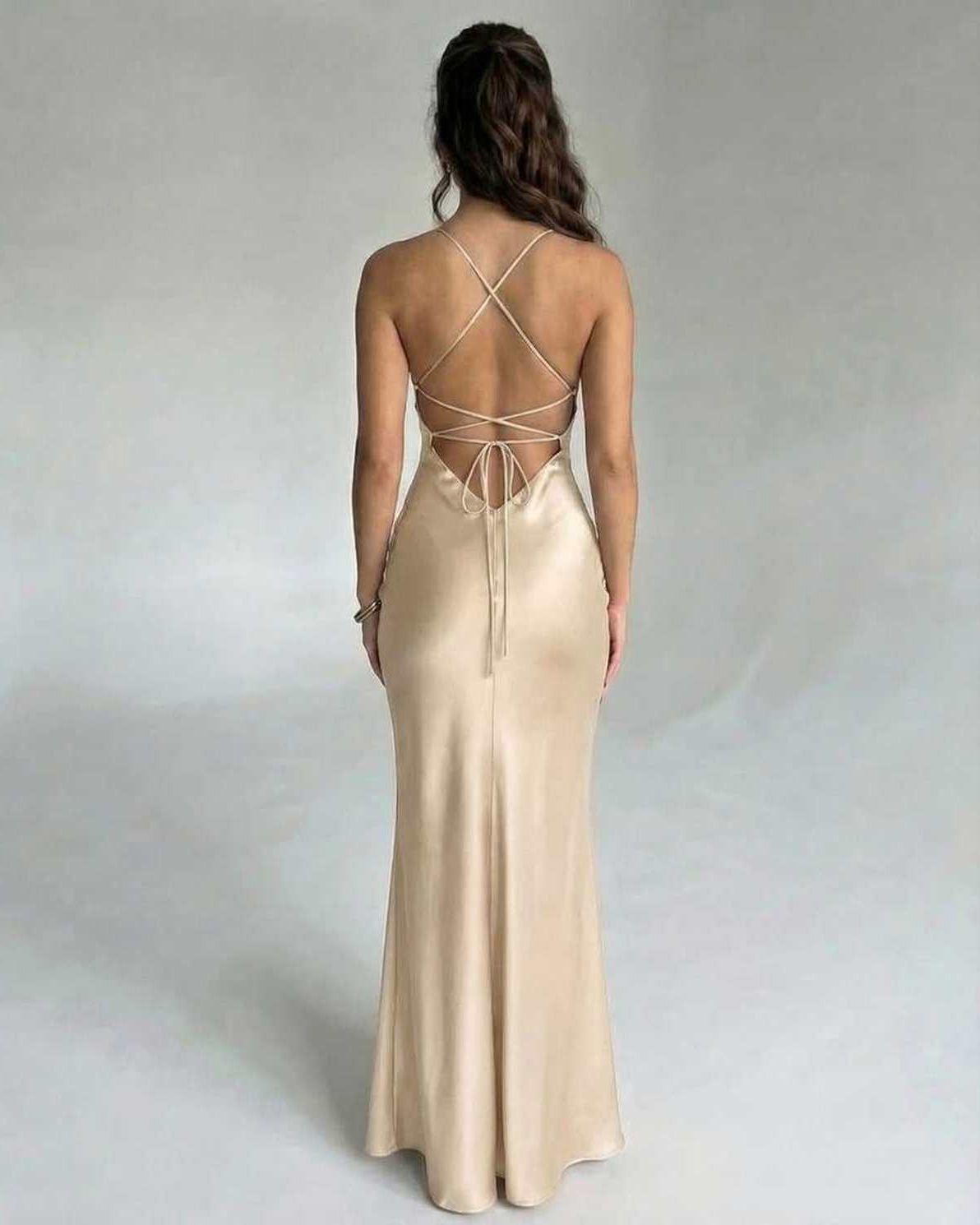 Back view of the Solstice Maxi Dress by Lauven in elegant satin champagne, featuring spaghetti straps and a chic silhouette.