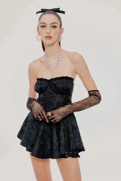 Stylish black mini dress with lace details and off-shoulder design, ideal for cocktail or party occasions.