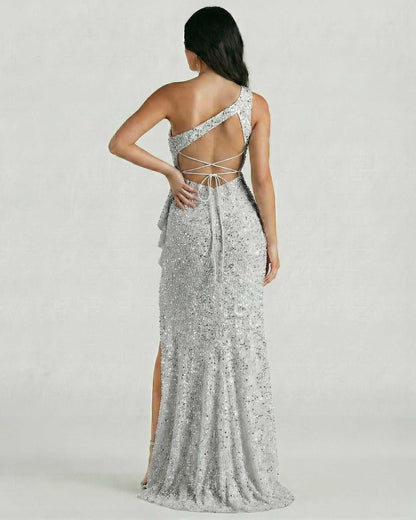 Back view of Sorrento Maxi Dress by Lauven, showcasing silver sequins and one-shoulder design with high slit.