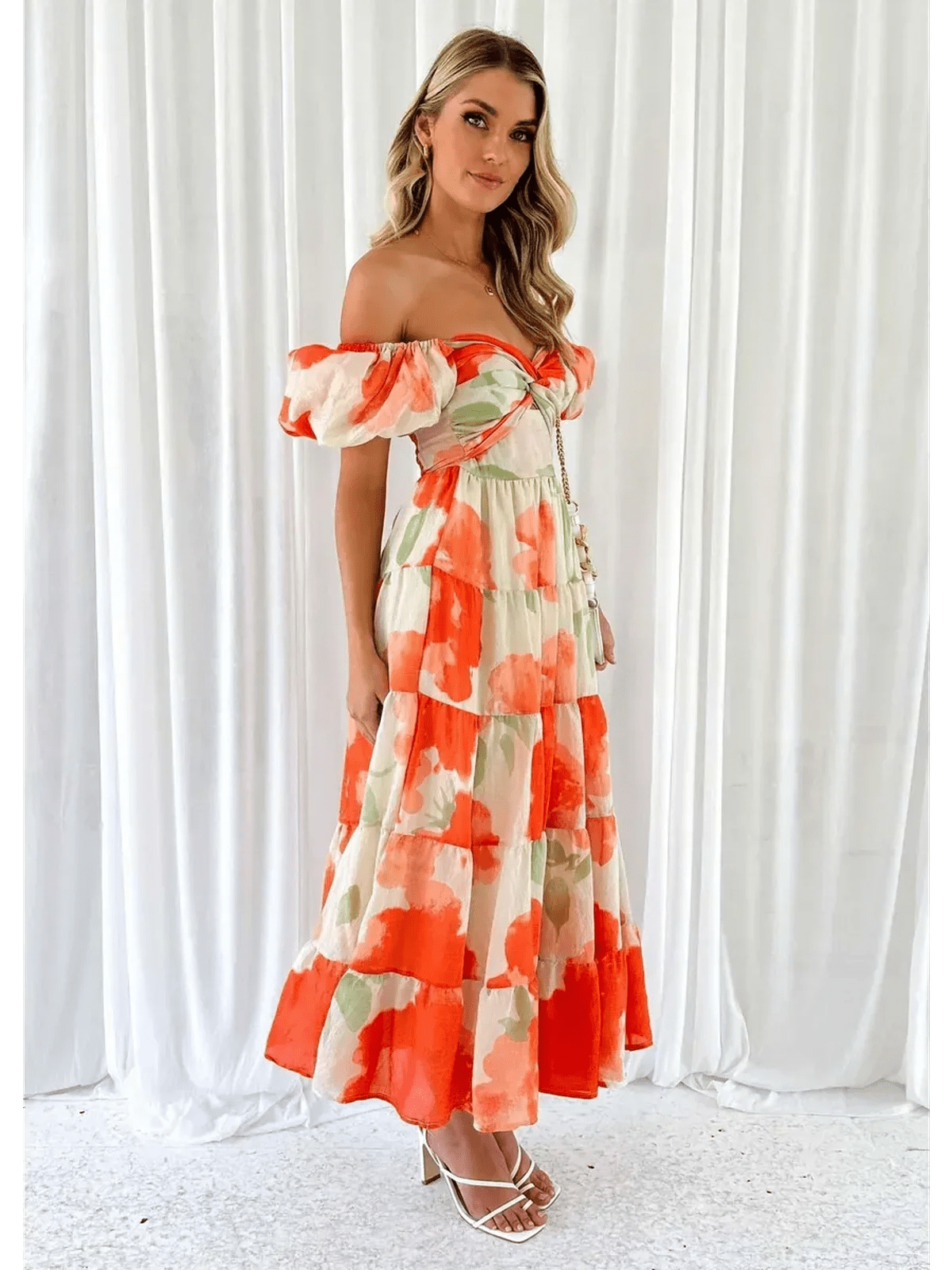 Sunset Bloom Maxi Dress featuring off-shoulder design and tiered ruffles in vibrant floral print, perfect for weddings or summer events.