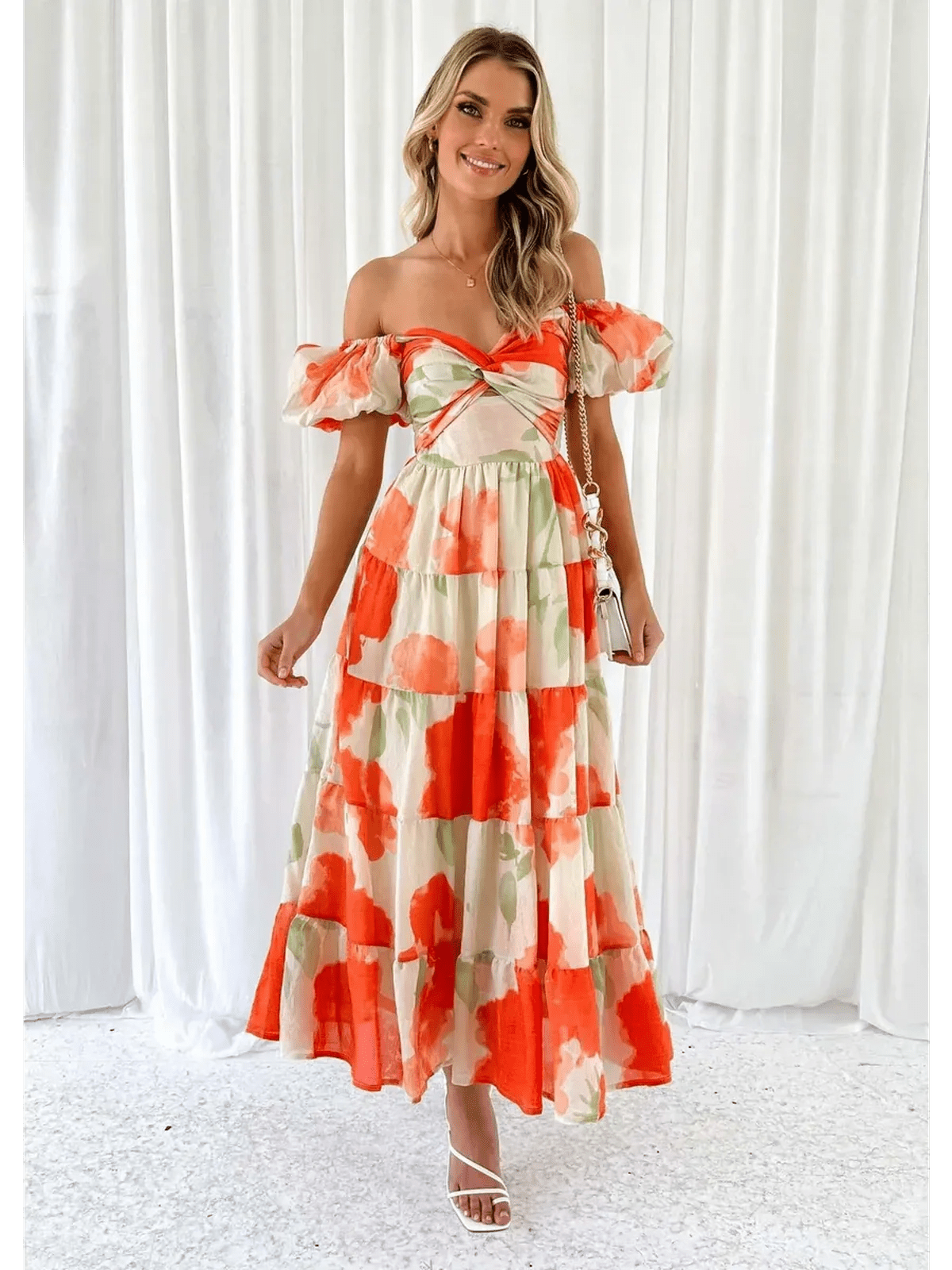 Woman in a vibrant off-shoulder maxi dress with tiered ruffles and floral patterns, perfect for sunny days.