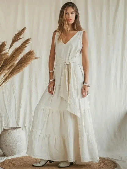 Model showcasing the Suntrace Maxi Dress in lightweight linen, featuring a belted waist and tiered hem on a neutral backdrop.
