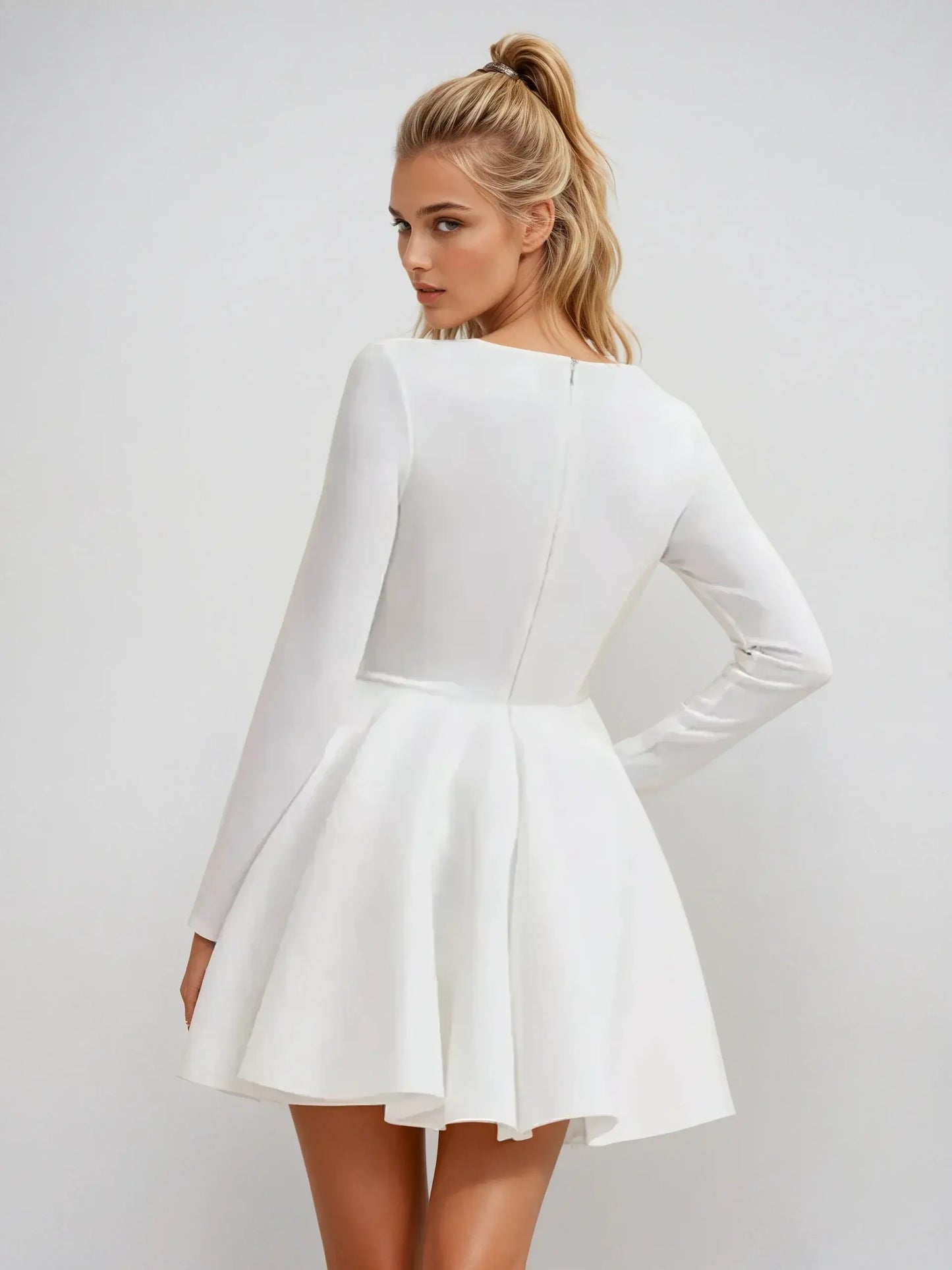 Back view of a white long sleeve fit-and-flare mini dress, perfect for summer, weddings, or cocktail events.