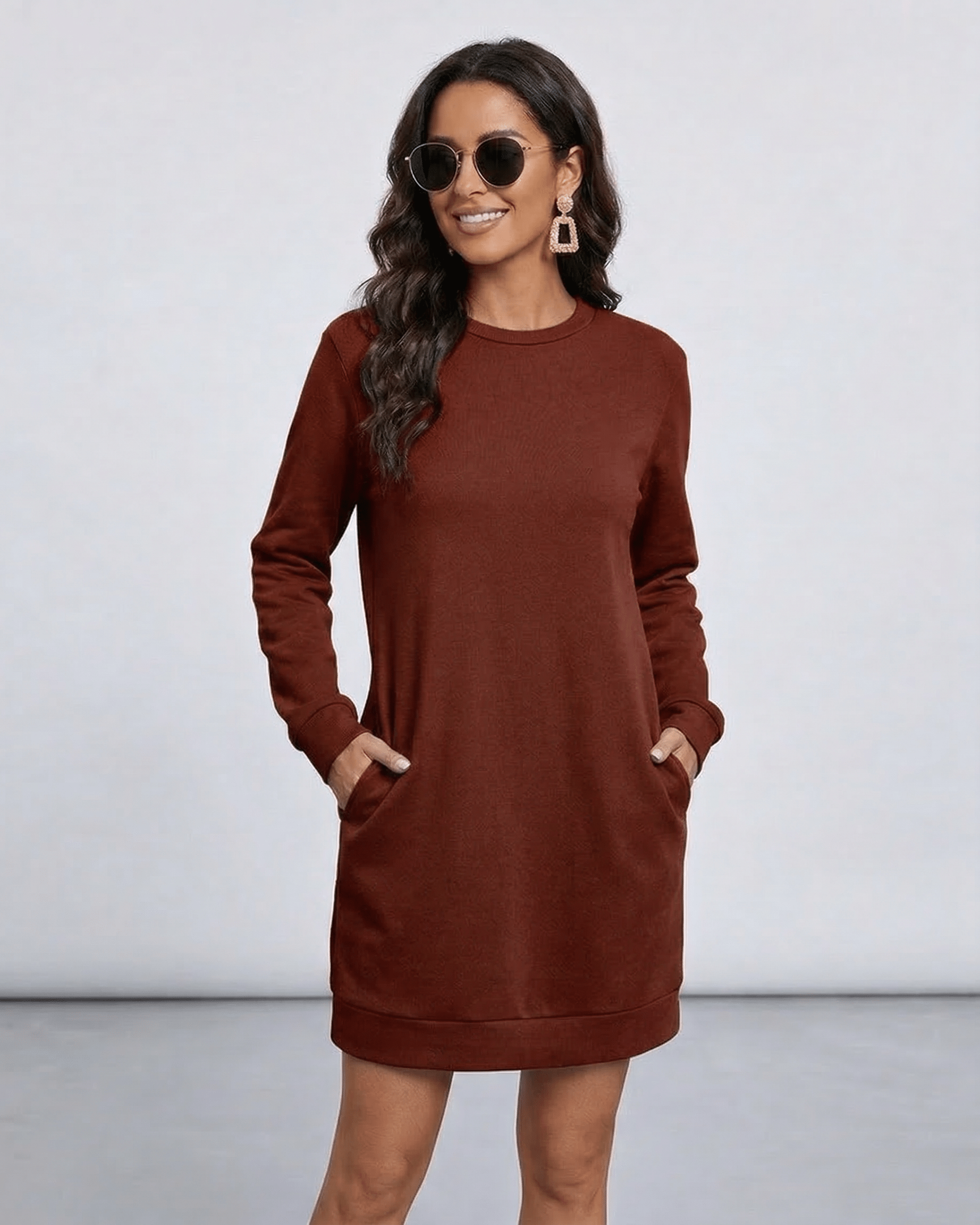 Model wearing Terra Mini Dress by Lauven in rich brown with sunglasses, featuring O neck and long sleeves.