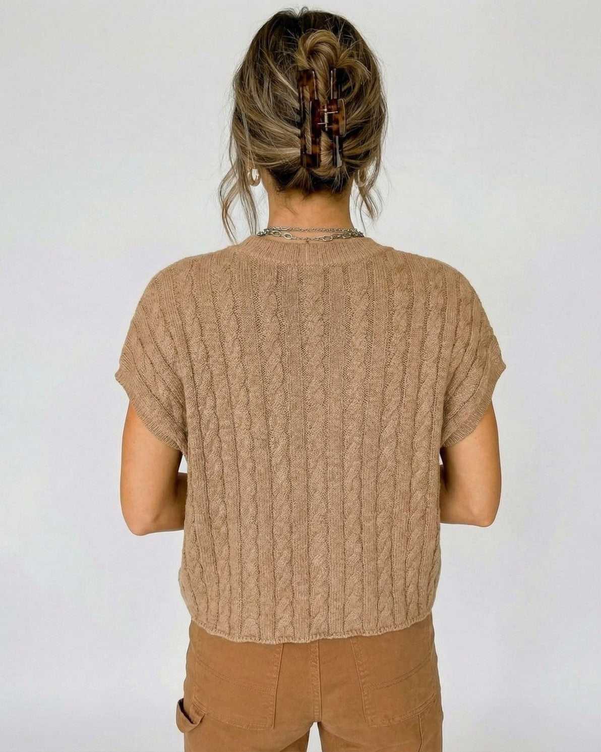 Back view of a model in a Toscana Sweater by Lauven, showcasing the cable knit design and relaxed fit.