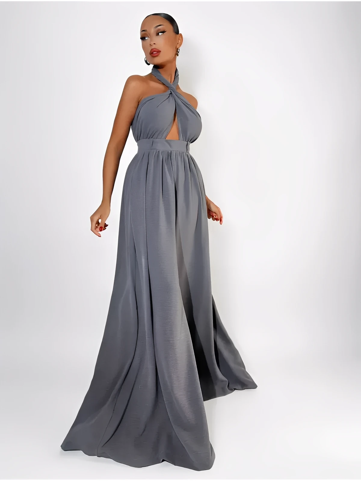 Twist Halter Jumpsuit in grey with open back and wide-leg silhouette, showcasing modern elegance and sophistication.