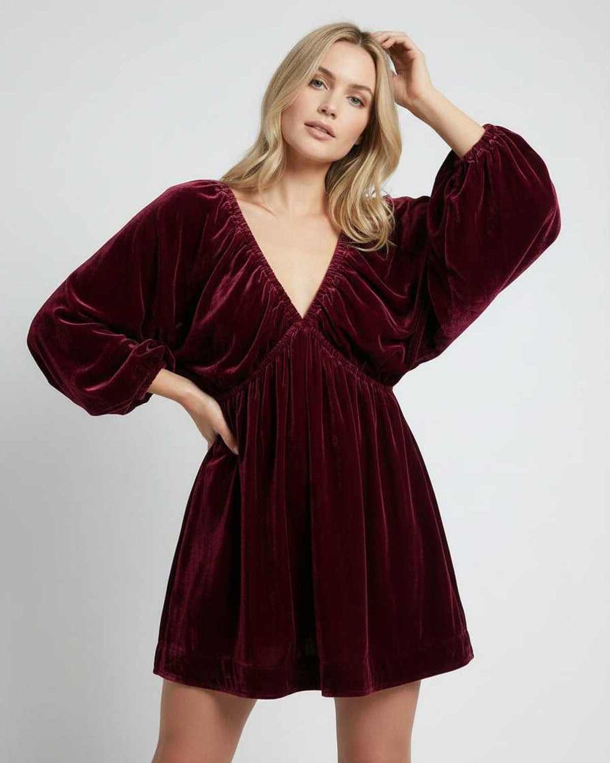 Valencia Mini Dress in burgundy velvet, featuring long sleeves and V neck silhouette by Lauven, offering elegance and comfort.