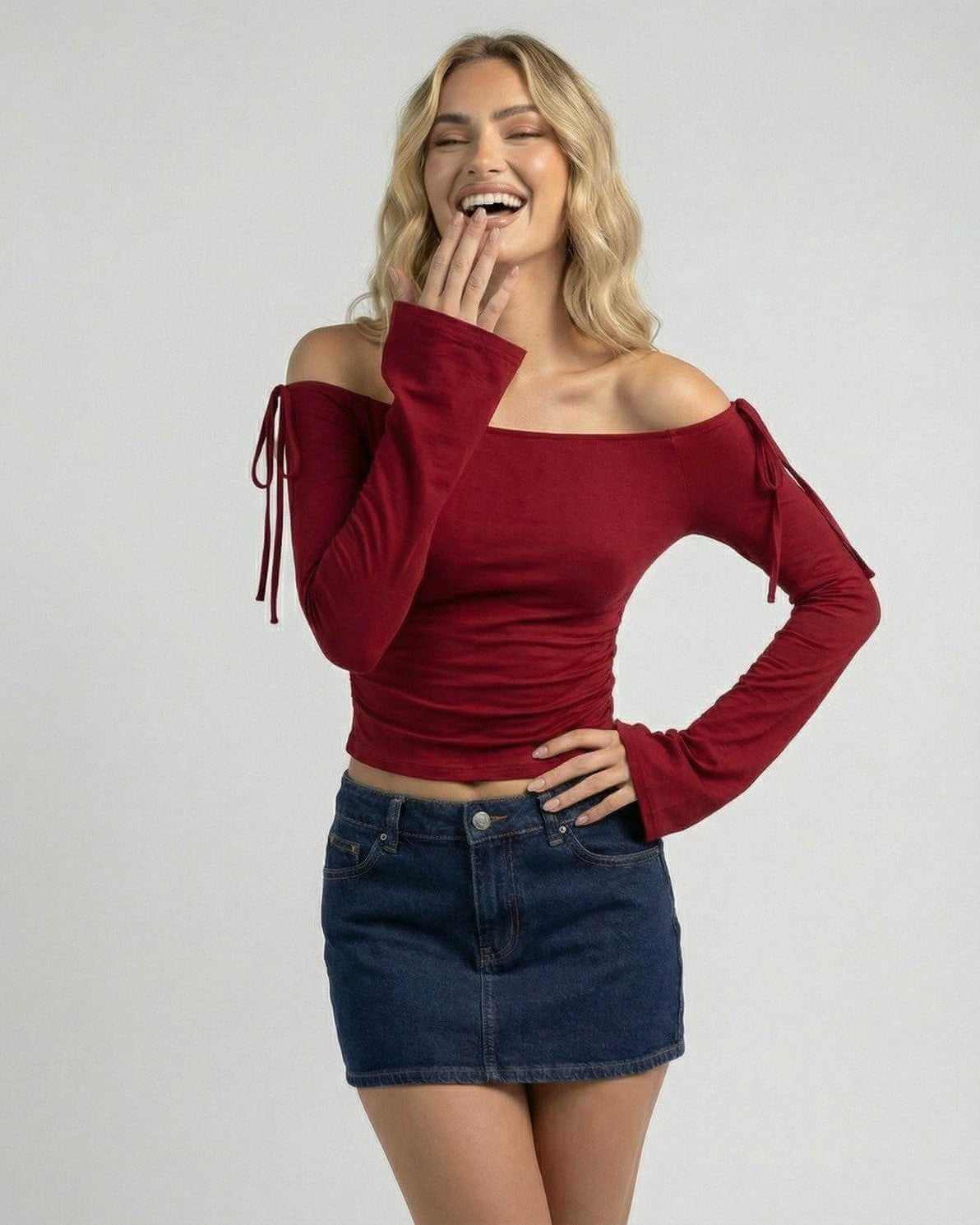 Woman wearing the Valencia Top by Lauven, an off-the-shoulder burgundy slim fit top with stylish sleeves.