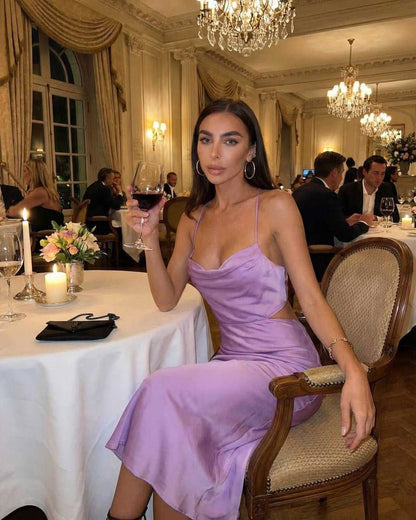 Vega Midi Dress in elegant lilac, sleeveless design worn at a dinner event, showcasing luxury and sophistication.