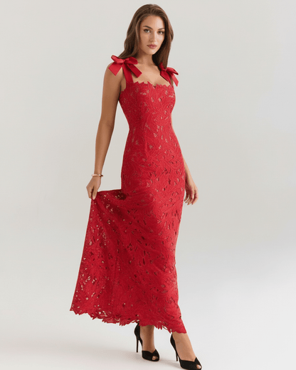 Model wearing Velmira Maxi Dress, a red lace maxi dress with square neckline and shoulder ties, perfect for formal occasions.