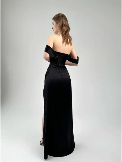 Back view of Velour Nights Maxi Dress showcasing off-shoulder design and sweeping silhouette with high slit.