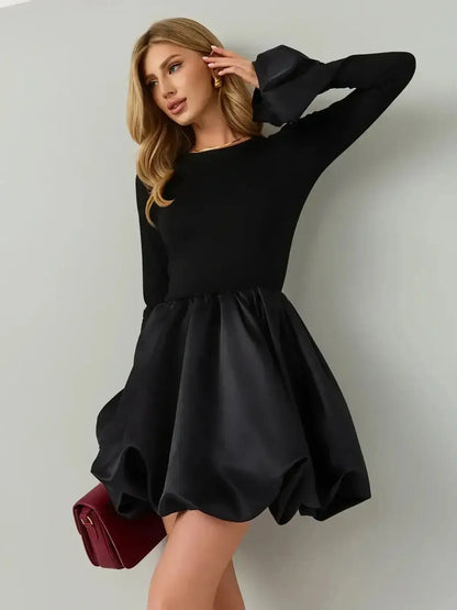 Model showcasing Velvet Bloom mini dress with a black knit bodice and satin balloon skirt.