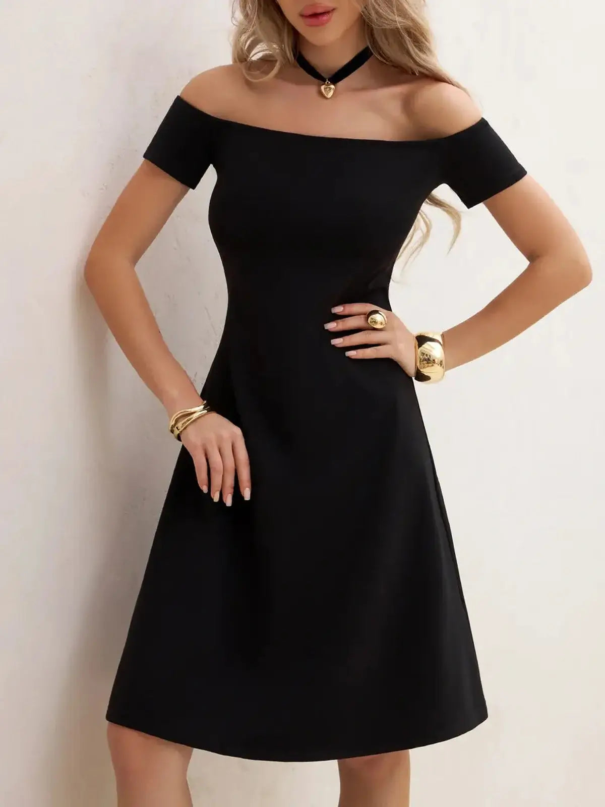 Elegant black off-shoulder mini dress in A-line silhouette, perfect for weddings and summer parties.
