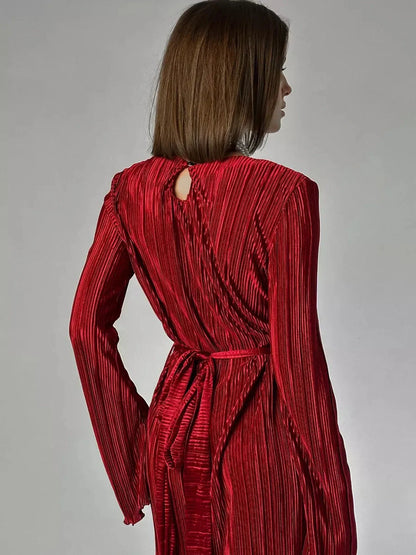 Back view of the Velvet Flame Maxi Dress showcasing glossy marsala pleats and a keyhole detail.