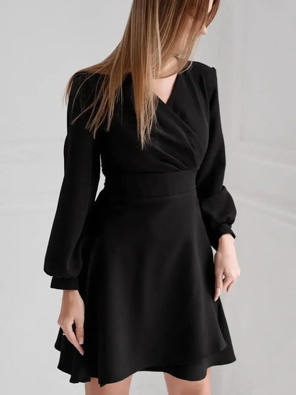 Elegant black midi dress with V-neckline and puff sleeves, perfect for weddings and formal occasions.