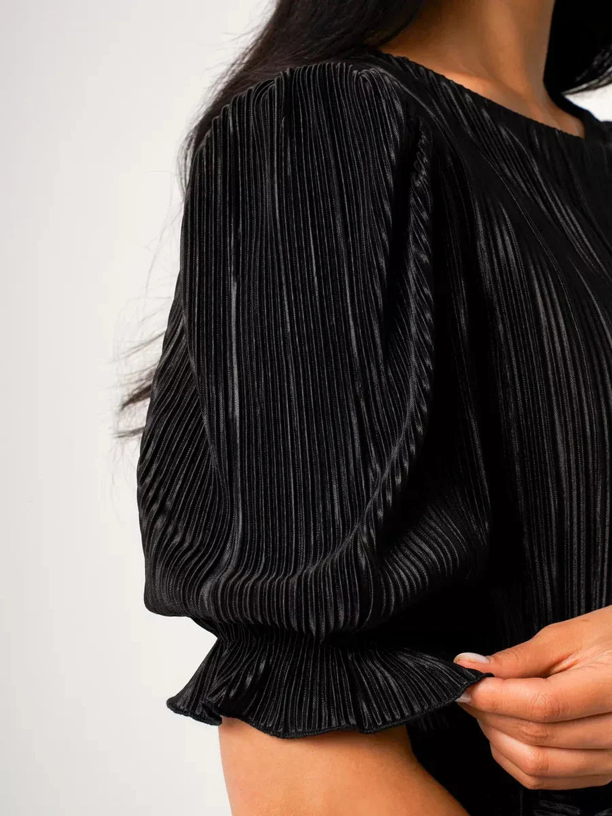 Close-up of puff sleeves on the Velvet Rhythm Maxi Dress, showcasing glossy micro-pleats and elegant texture.