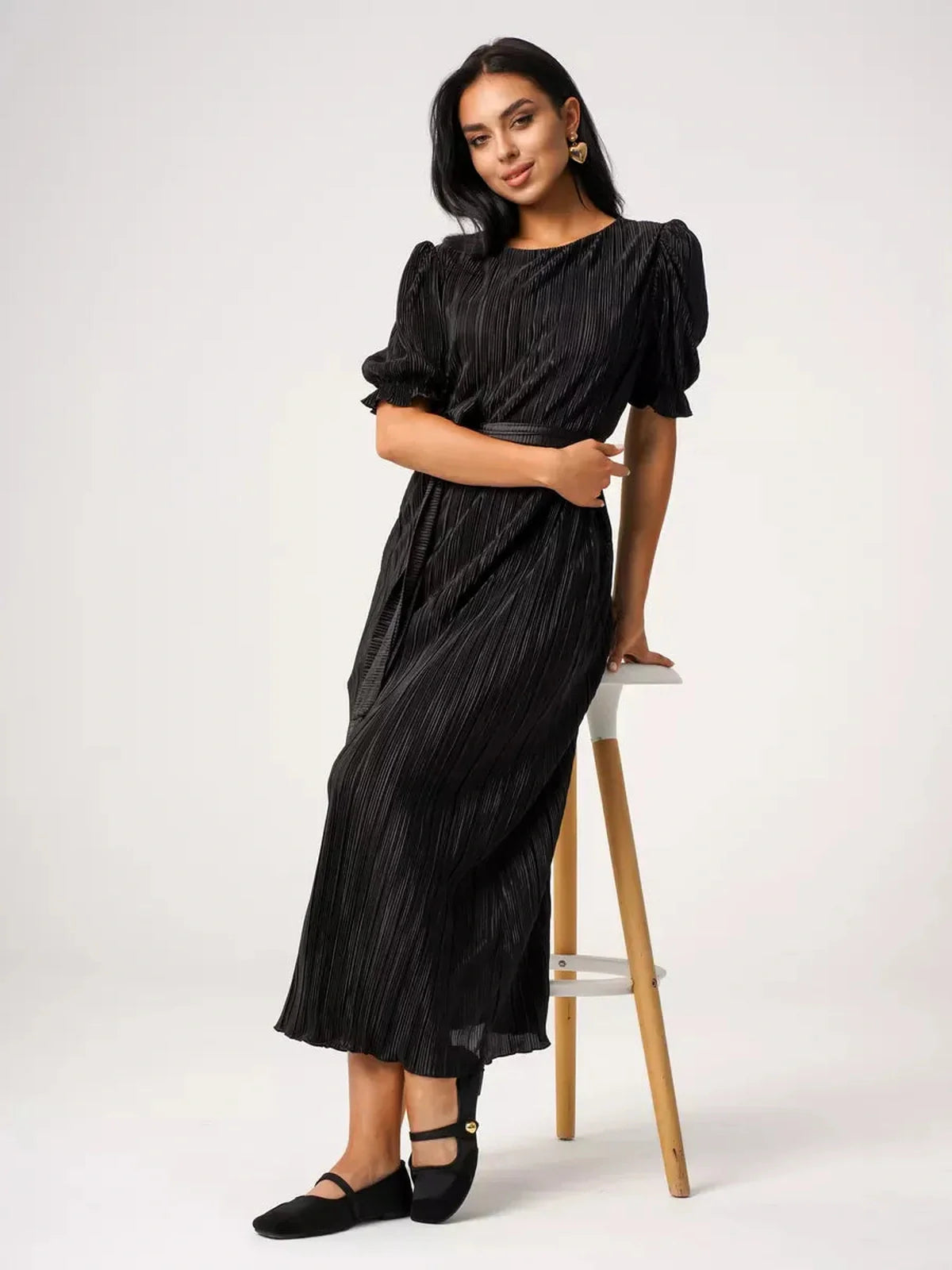 Model wearing Velvet Rhythm Maxi Dress with pleated texture and puff sleeves, showcasing elegance and style.
