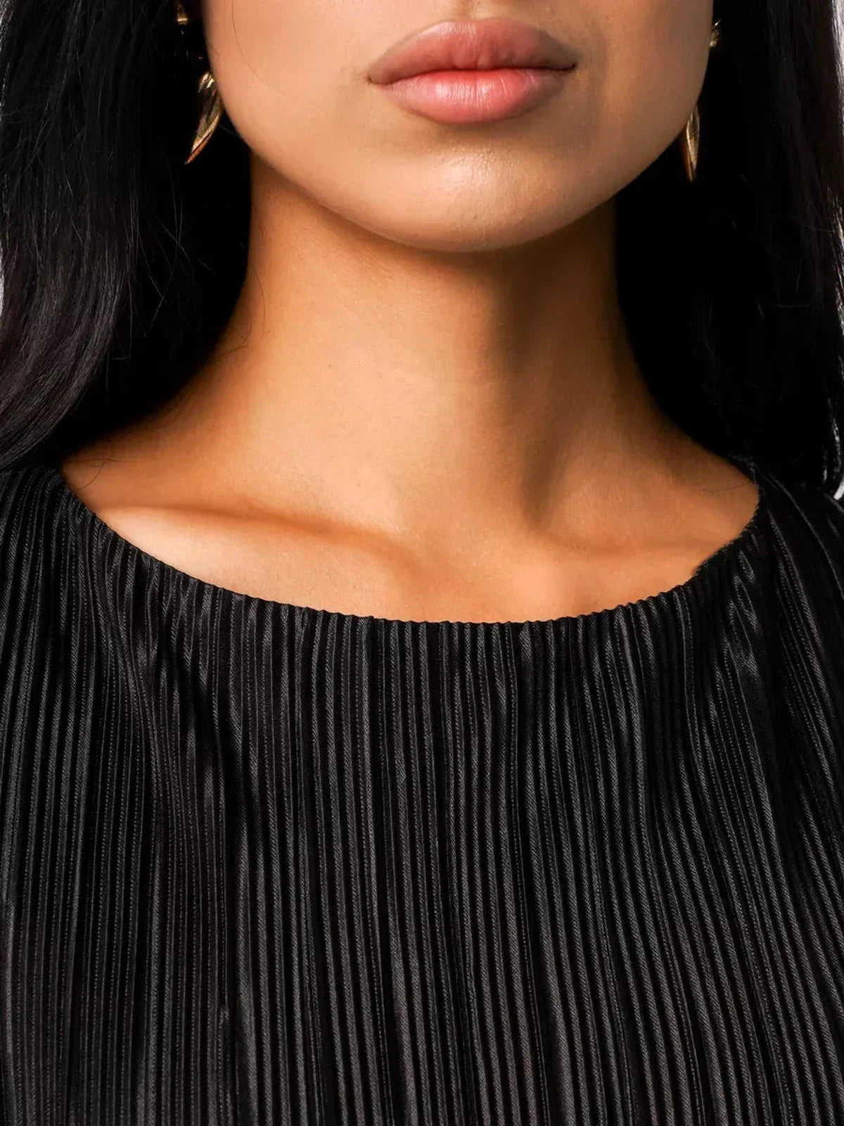 Close-up of a model showcasing the pleated neckline and elegant earrings of the Velvet Rhythm Maxi Dress.