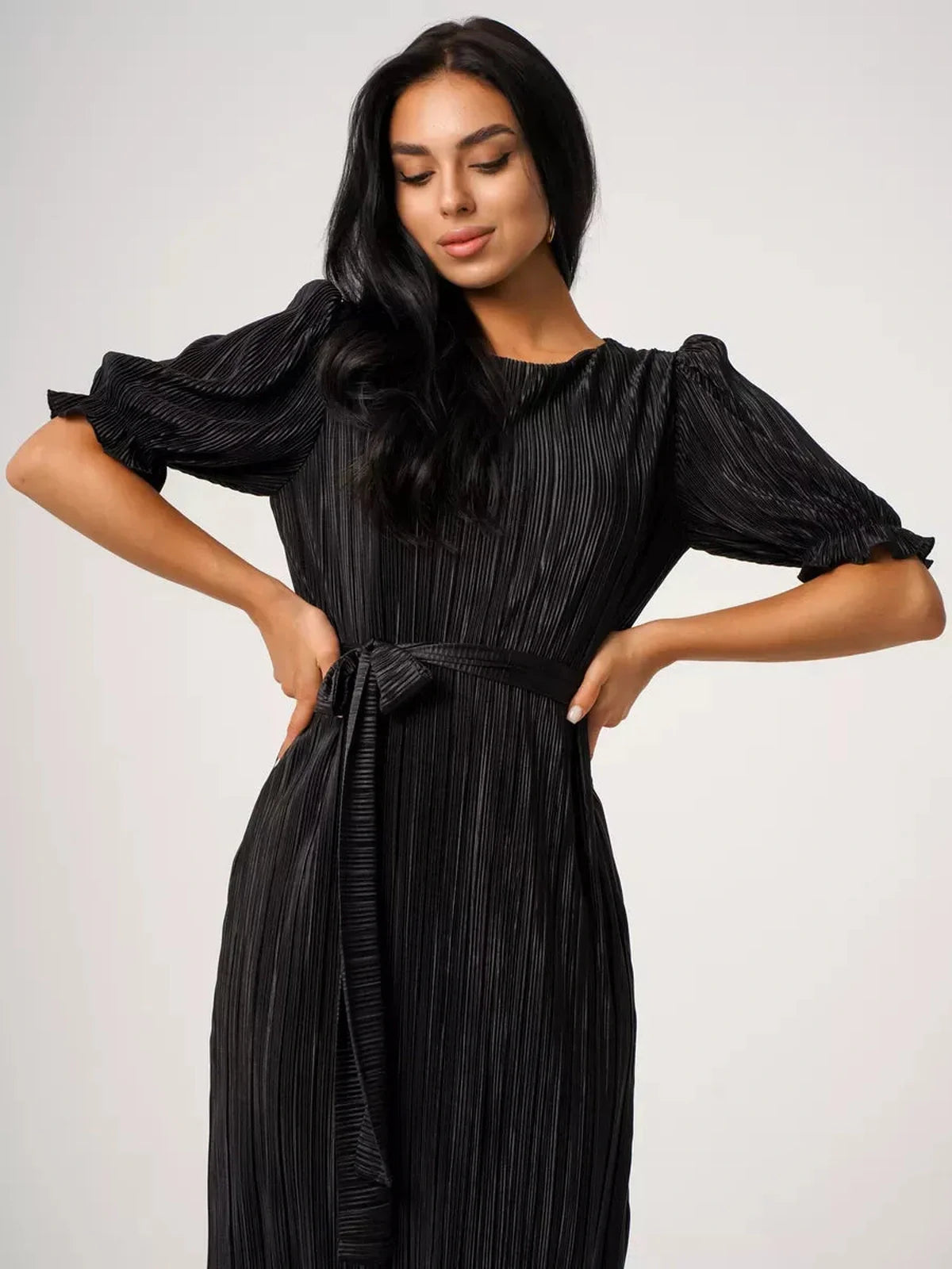Model showcasing the Velvet Rhythm Maxi Dress with pleated elegance and puff sleeves, featuring a detachable sash belt.