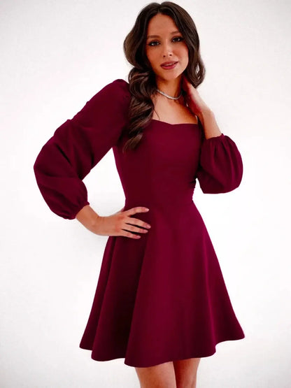 Chic deep burgundy mini dress with square neckline and voluminous long sleeves, perfect for wedding guests or formal occasions.