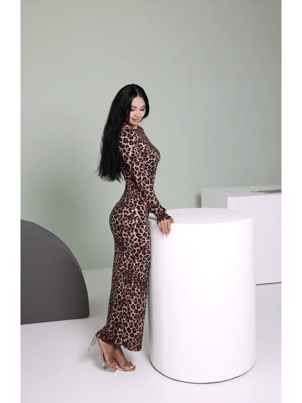Model showcasing the Velvet Wild Maxi Dress with leopard print, highlighting a form-fitting silhouette and elegance.