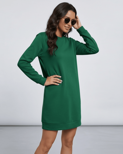 Model wearing the Lauven Verde Mini Dress in emerald green, featuring long sleeves and a casual fit.