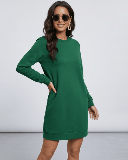 Verde Mini Dress by Lauven worn by a model, showcasing the casual emerald green sweatshirt dress with pockets.