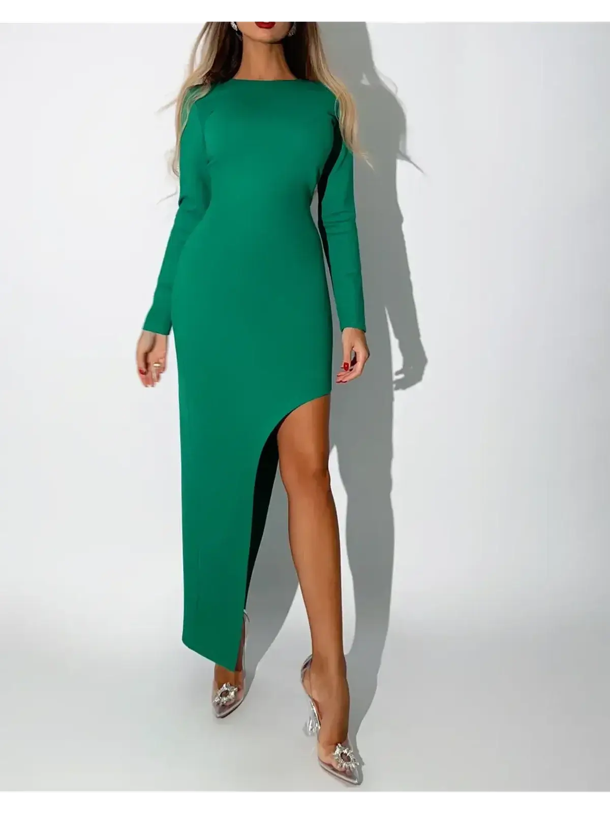 Verona Maxi Dress in emerald green, featuring a striking asymmetric hem and long fitted sleeves for sophisticated elegance.