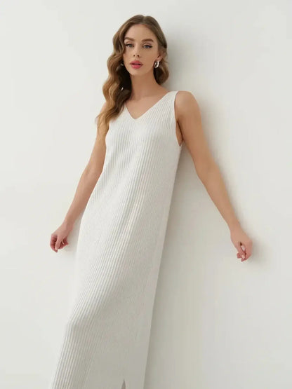 Model wearing the elegant Verona Maxi Dress in white ribbed knit, featuring a side slit and minimalistic design.