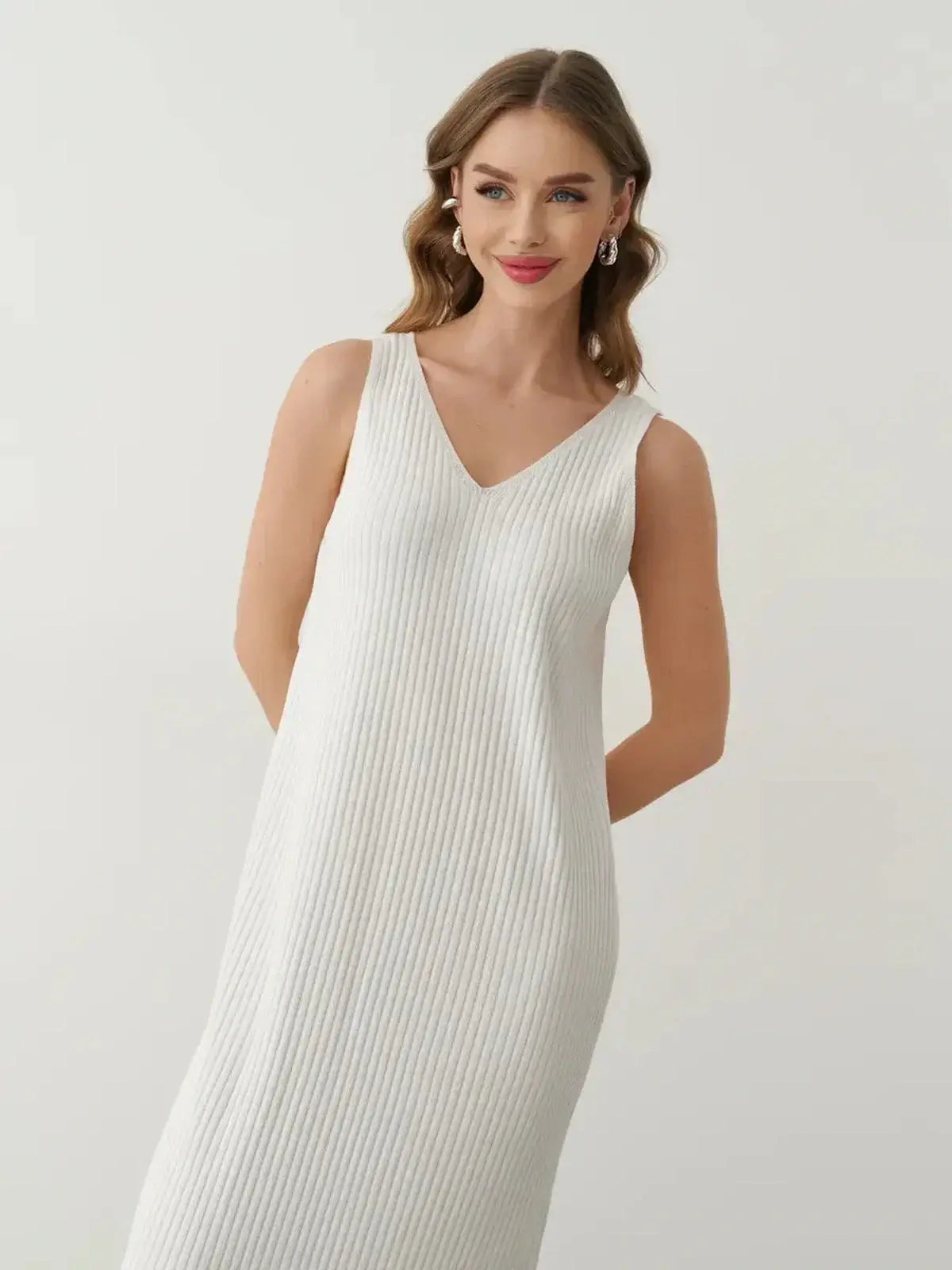 Model wearing the Verona Maxi Dress, a white ribbed cotton-acrylic knit dress, showcasing elegance and style.