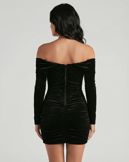 Verona Mini Dress by Lauven - Back view of black velvet off shoulder mini dress with long sleeves.