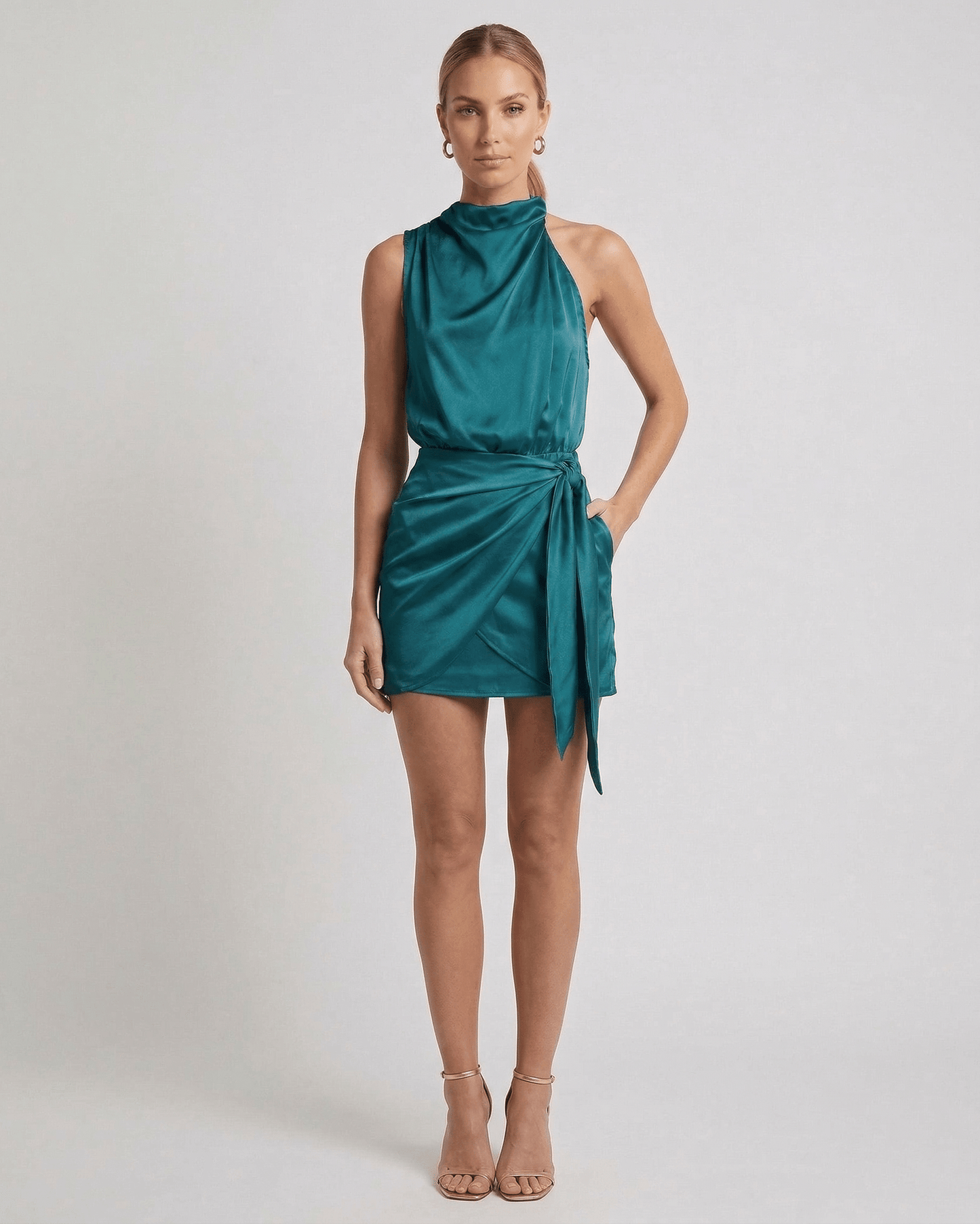 Verona Mini Dress by Lauven – Emerald satin mini dress with draped high neck and wrap tie detail.