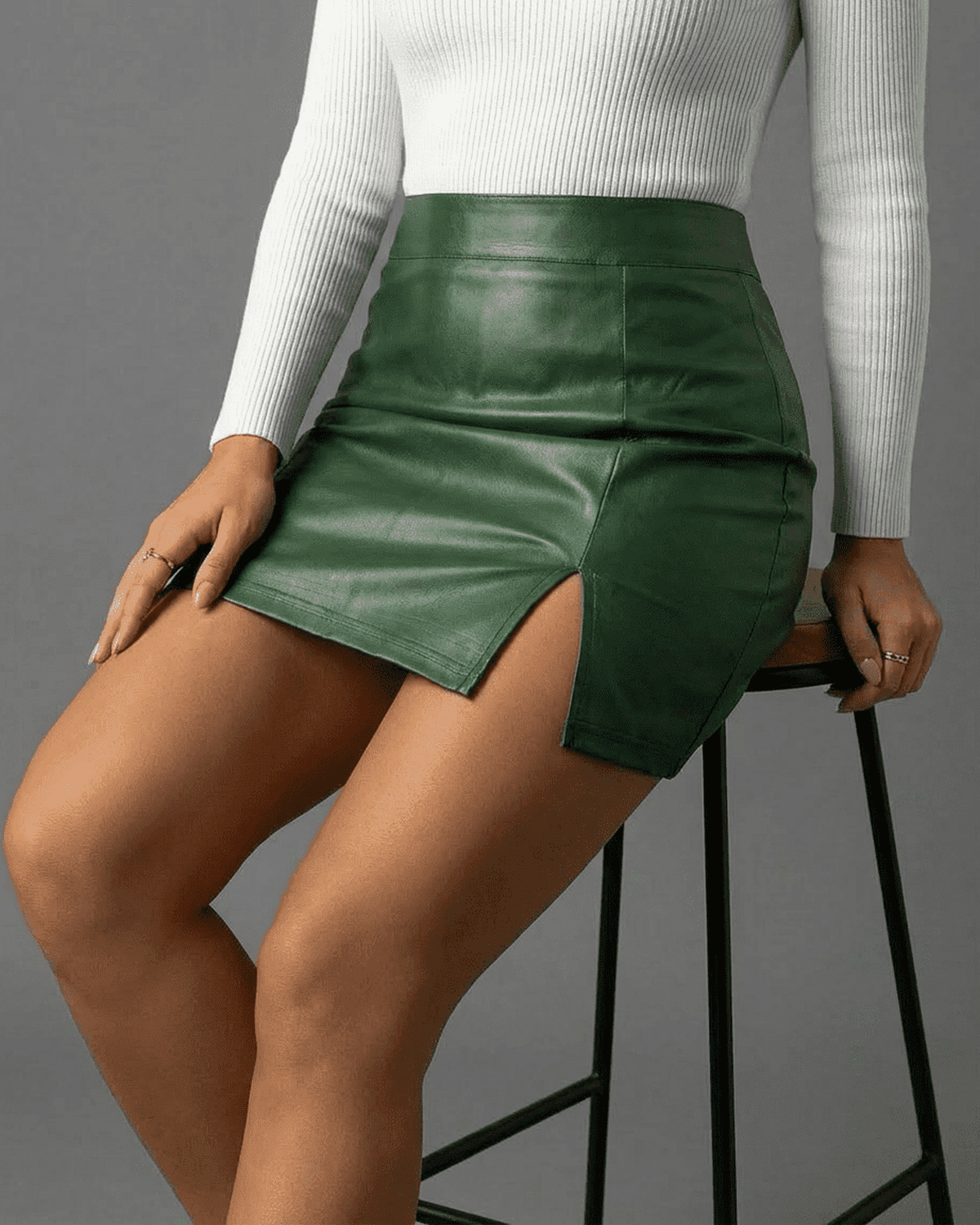 Verona Mini Skirt by Lauven in rich green, high-waisted PU A-line with side slit, perfect for modern elegance.