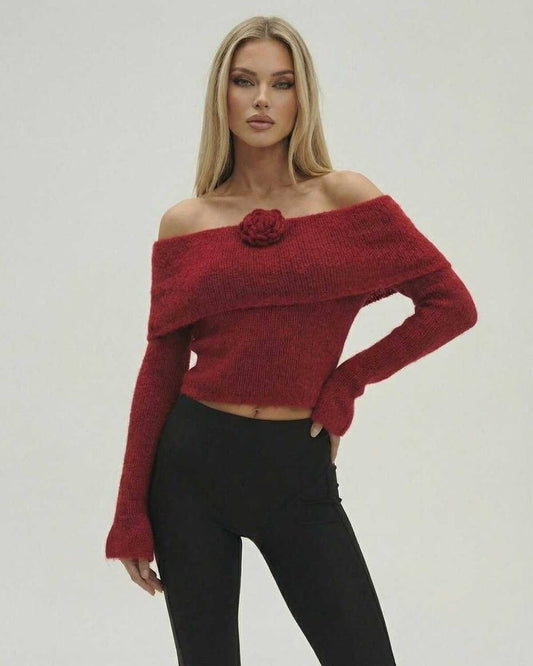 Woman in red Verona Pullover off the shoulder sweater by Lauven, featuring long sleeves and a stylish rose detail.