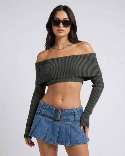 Model wearing the Verona Top, a women's off shoulder long sleeve crop top by Lauven, styled with a denim skirt.