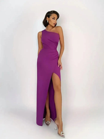 Model showcasing the Violet Mirage Maxi Dress, a one-shoulder purple gown with a thigh-high slit and sculpted silhouette.
