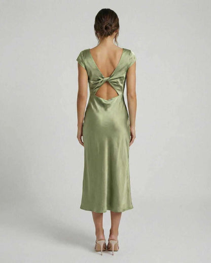 Virgo Midi Dress featuring a twisted-back and cutout detail in soft sage green, by Lauven. Elegant satin design.