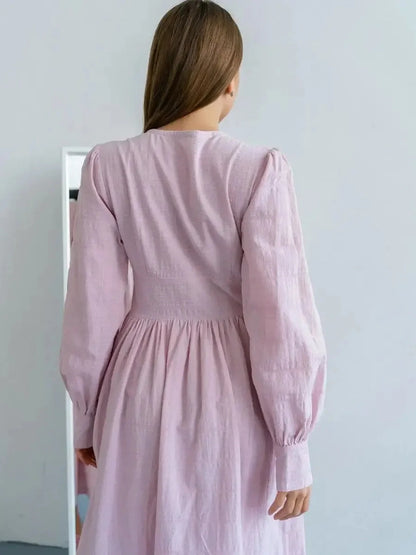 Back view of the Willow Grace Maxi Dress showcasing elegant sleeves and cinched waist in soft pink cotton.