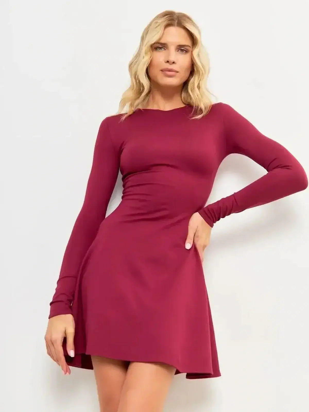 Model showcasing the Wine Flare Mini dress in burgundy, featuring a fitted bodice and flare hem for a chic silhouette.