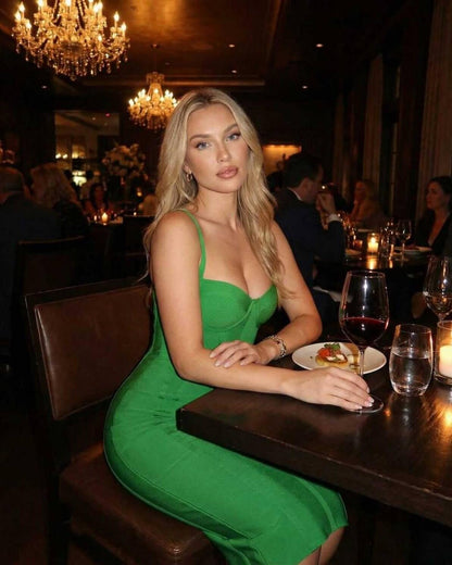 Zara Midi Dress by Lauven, featuring a sleek green bodycon design in a stylish dining setting.