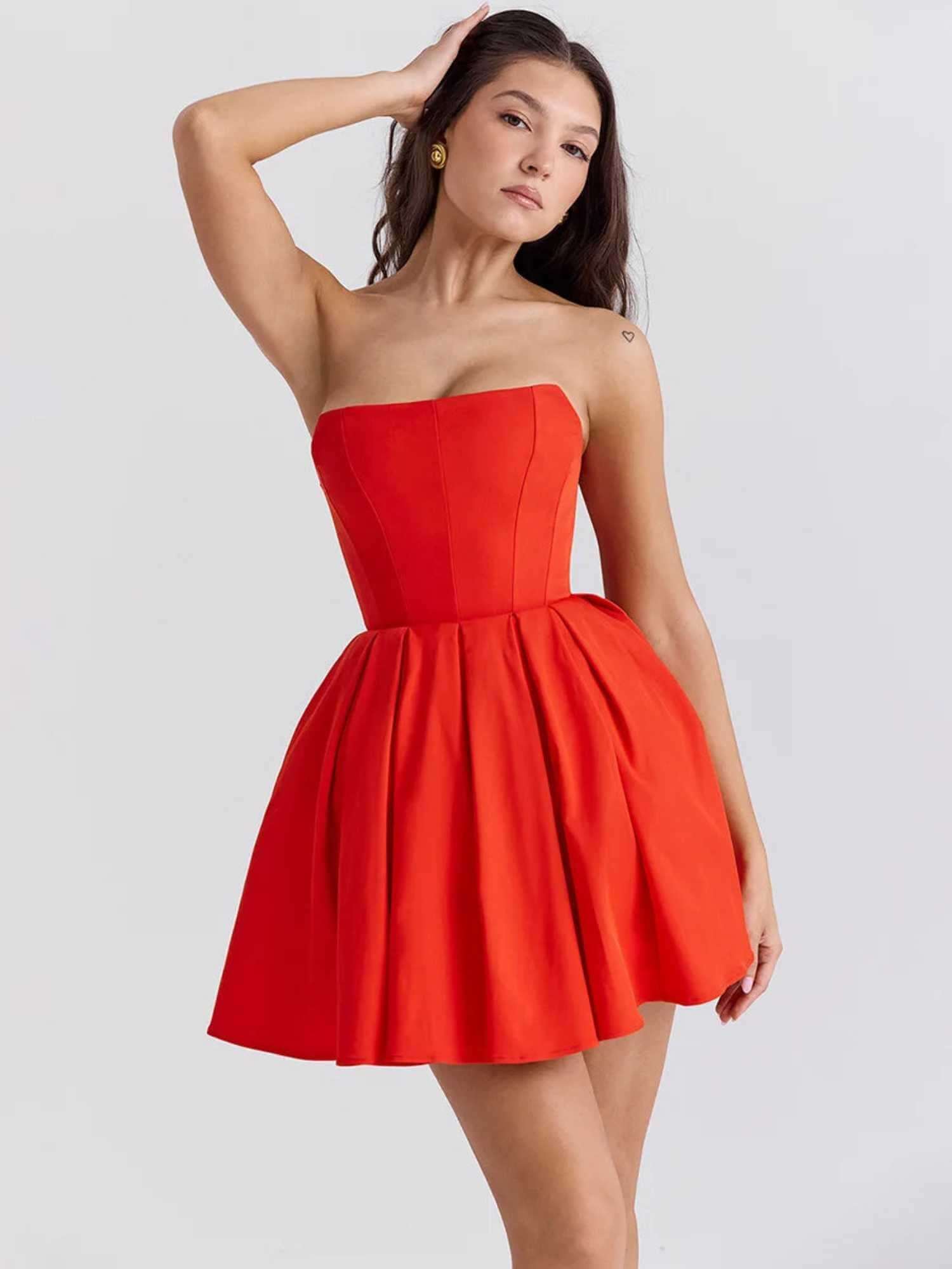 Red mini dress with a strapless corset bodice and pleated skirt, perfect for summer parties and cocktail events.
