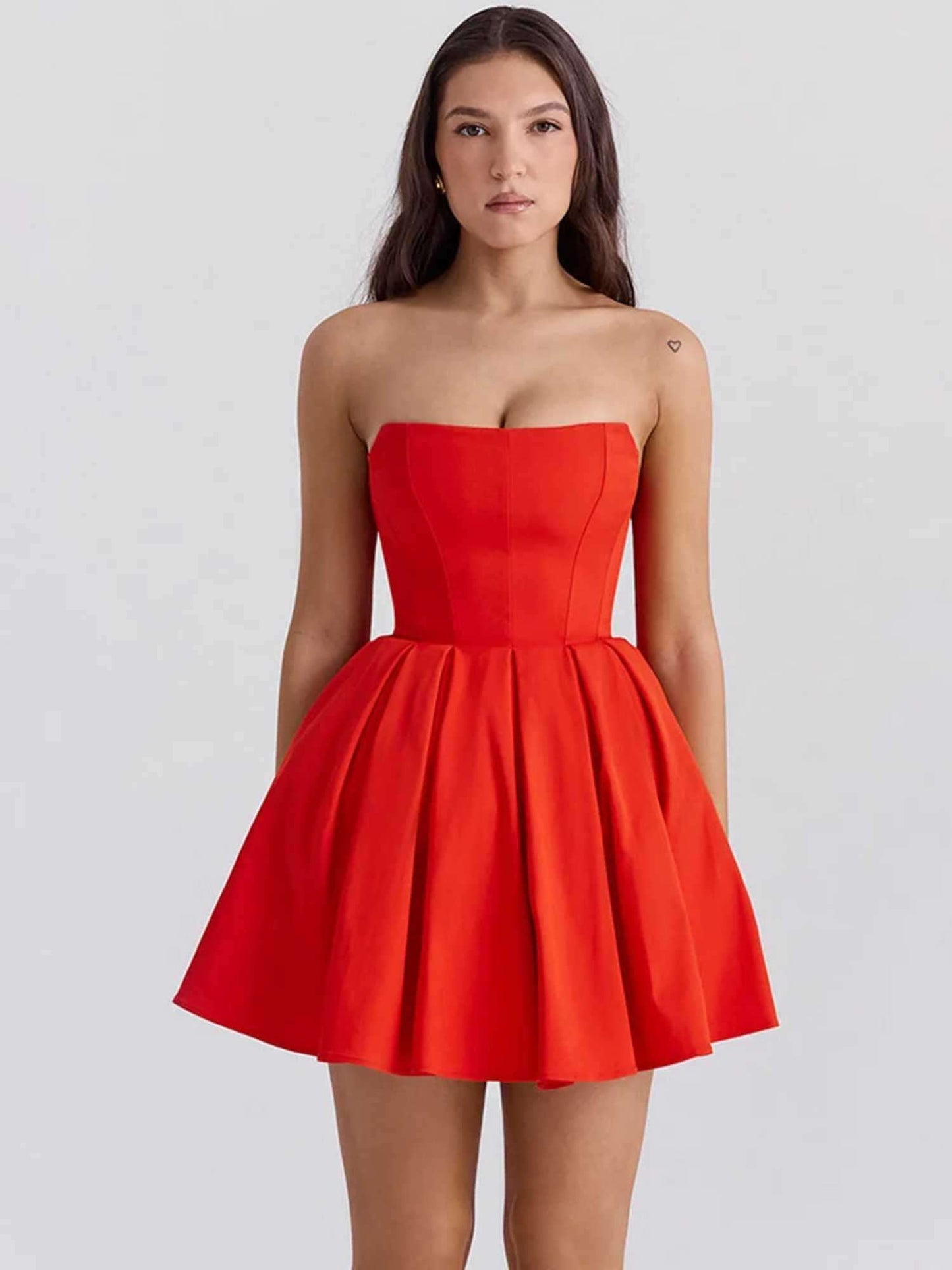 Red mini dress with strapless design and pleated skirt, perfect for summer parties and special occasions.