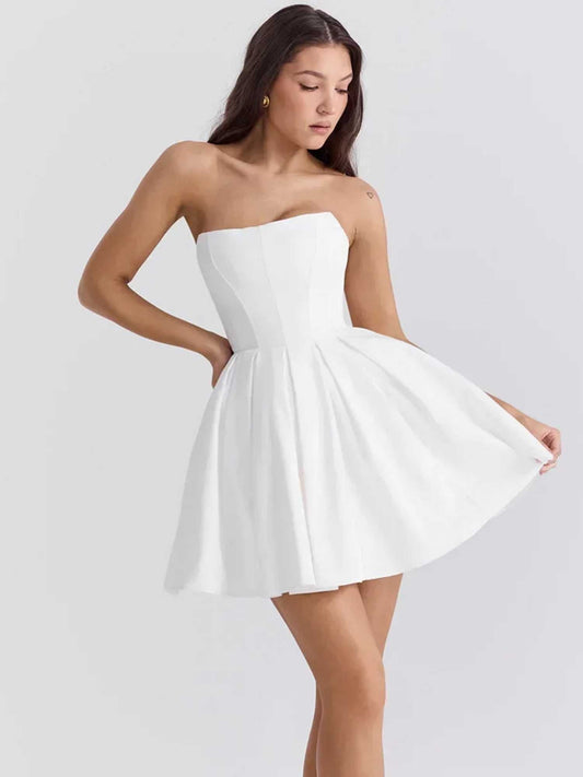 Zara mini dress in white featuring a strapless design and voluminous pleated skirt, perfect for summer and wedding guests.